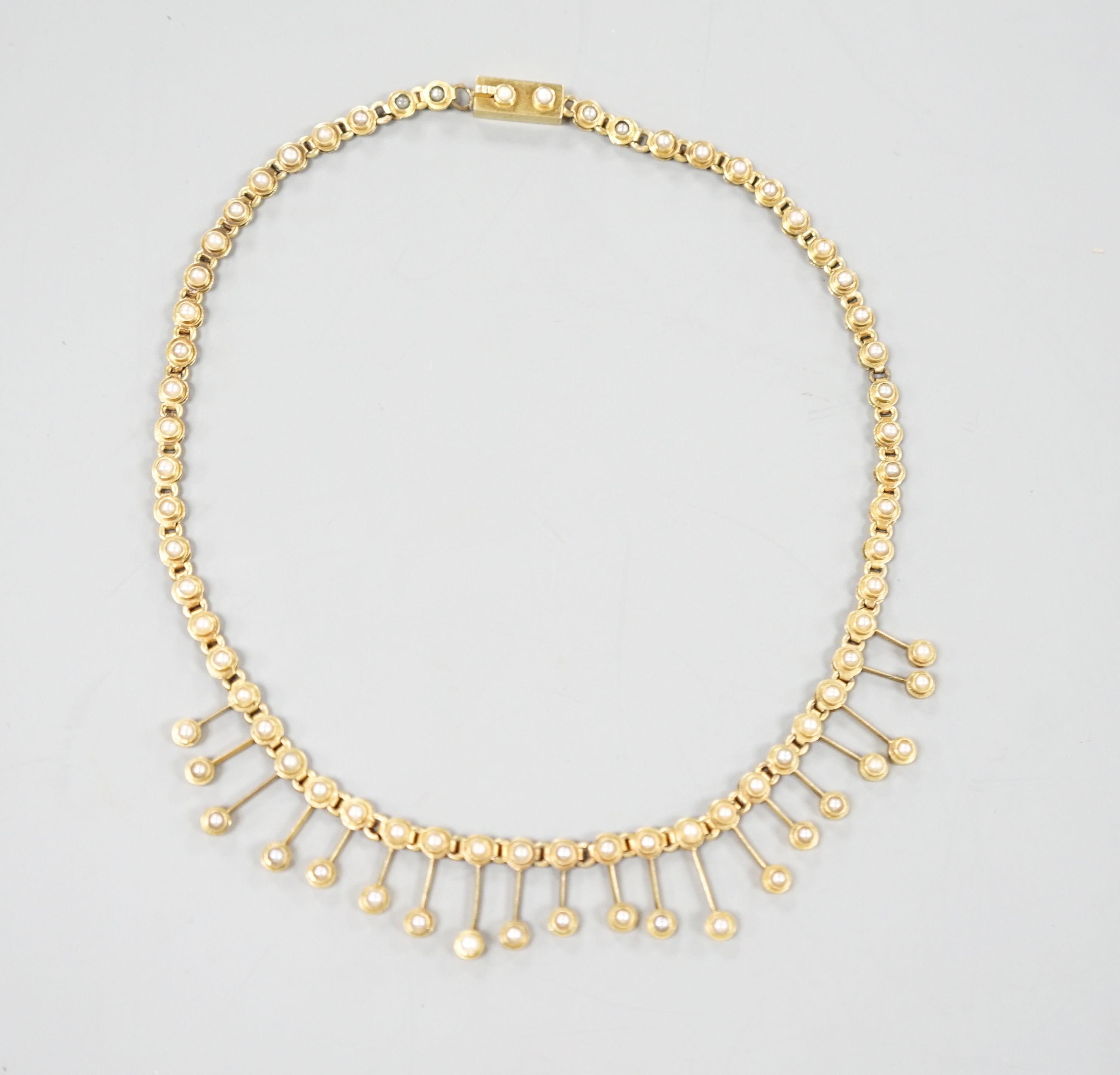 A late Victorian yellow metal and seed pearl set fringe choker necklace, 33cm, gross 18.4 grams.